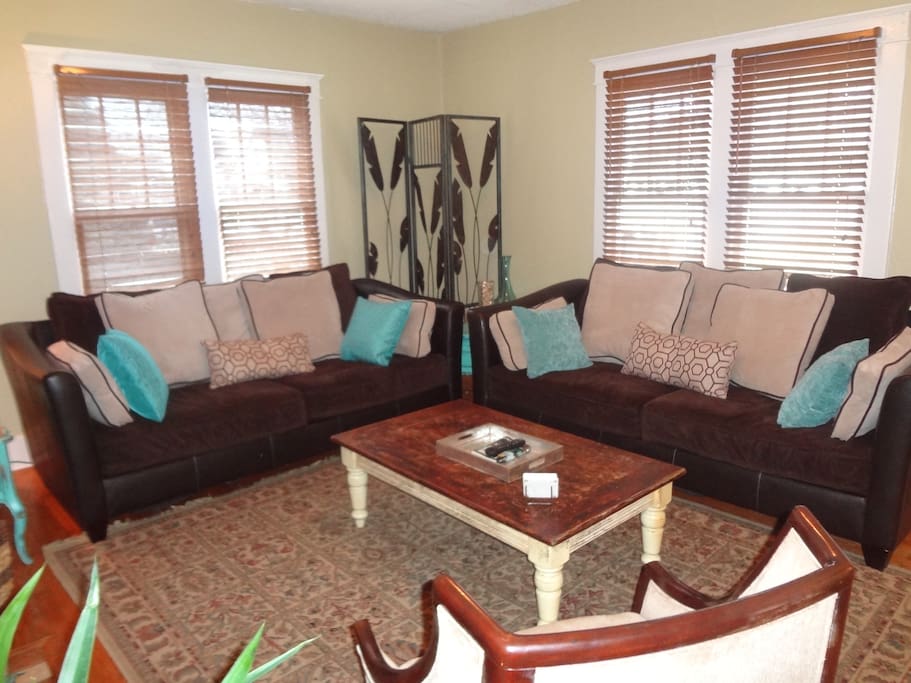 Welcome home to a cozy living room with plenty of seating and even a dog bed for our furry guests!