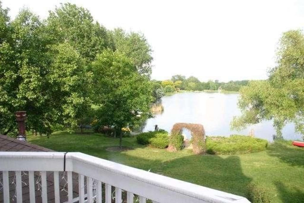 Main bedroom deck overlooking backyard and private beach on Lake Russo