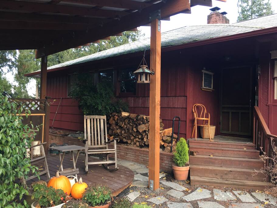 front of house with covered deck and gas grill as well as two rocking chairs...lovely view of the front garden!