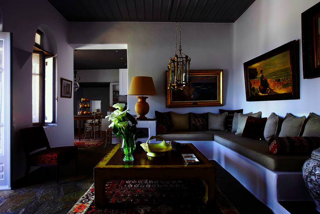 The living room is lovingly furnished and decorated with art by the owner, combining a traditional element with understated luxury.