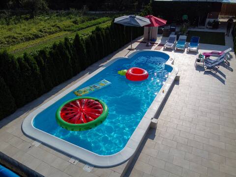 House with swimming pool next to the river