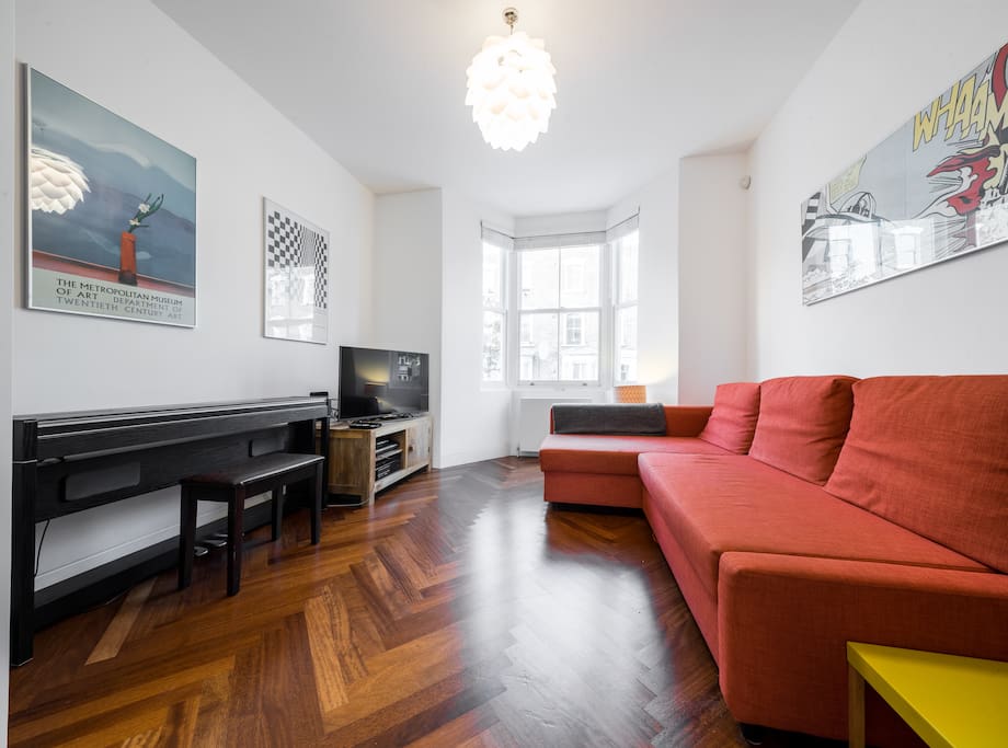 The other end of the room has a TV and a huge L-shaped sofa...