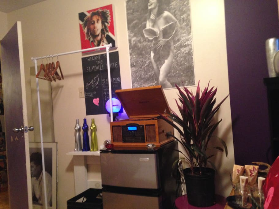Mini-fridge & freezer w/ turntable stereo and clothing rack.