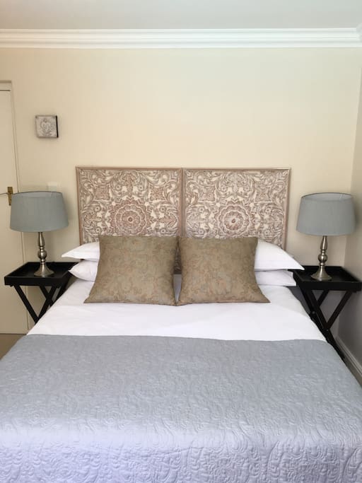 The main bedroom is decorated in tranquil summer neutrals and blues.