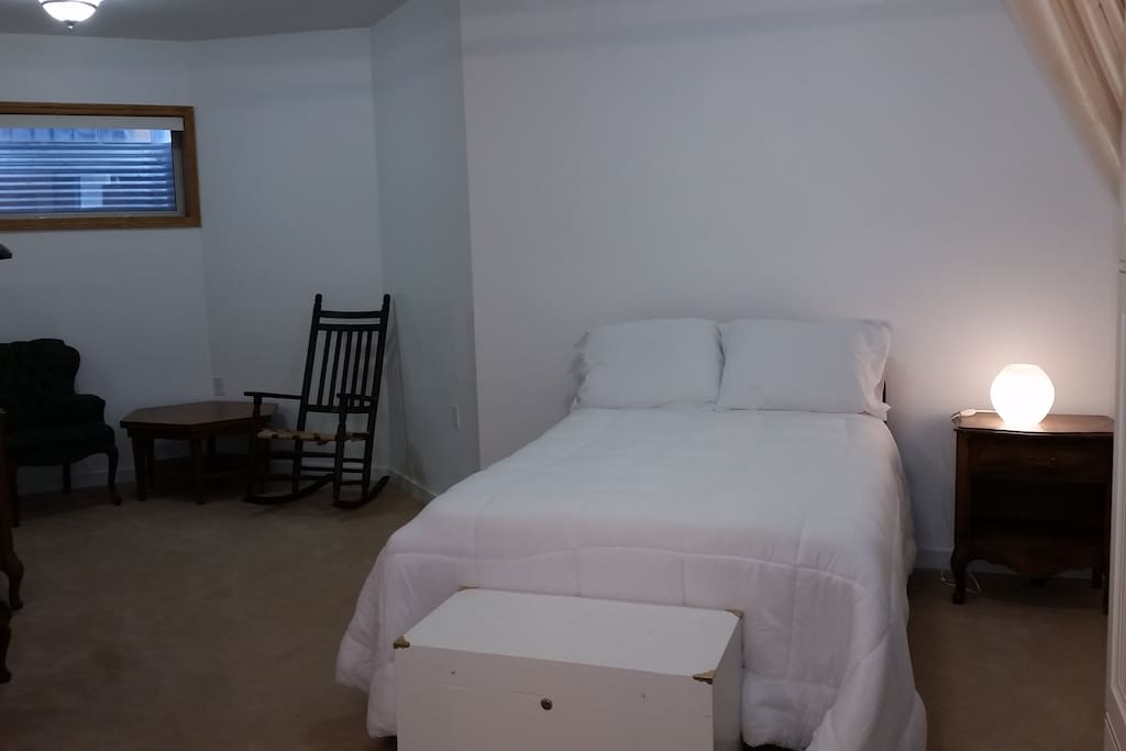 Huge bedroom area with window and seating area.