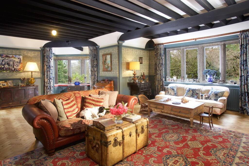 Living room leading to veranda, with open fireplace.