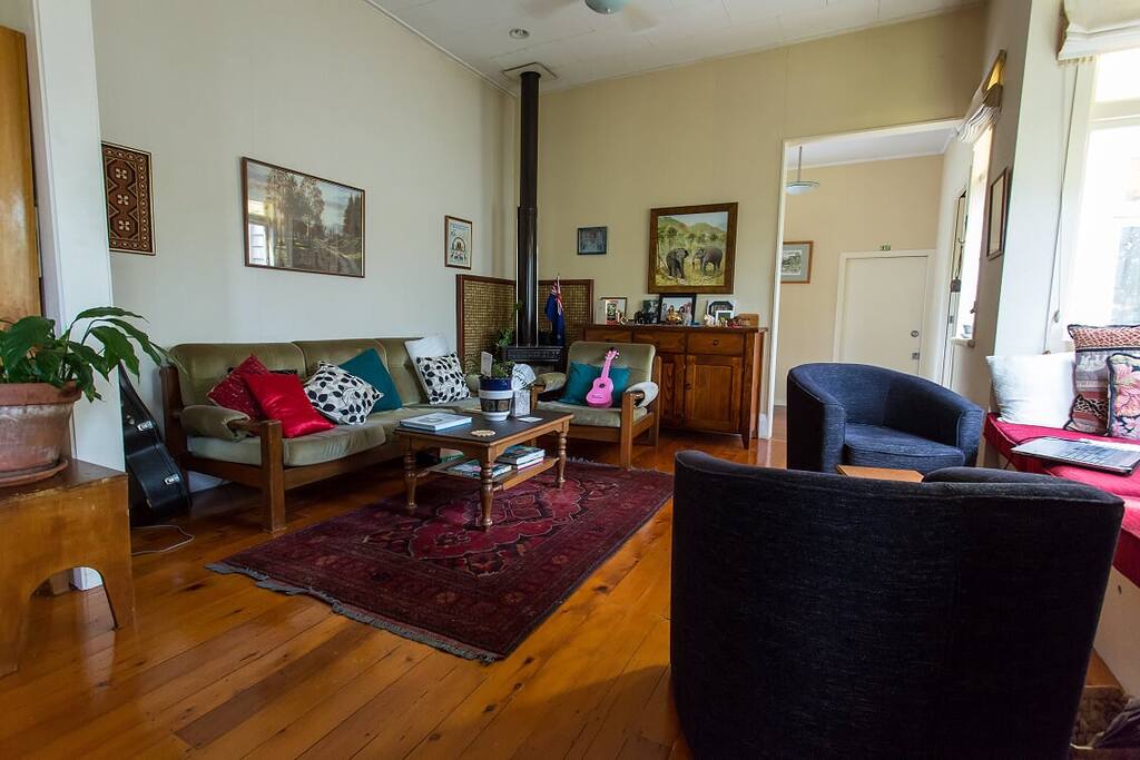 Photo taken from kitchen showing spacious open plan family room with baywindow on right side.