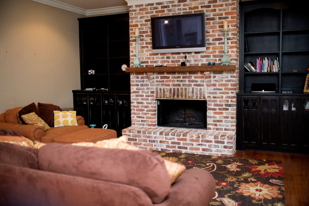 Living room with fireplace and built in cabinets