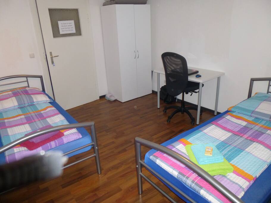 A comfortable, bright room for three person.