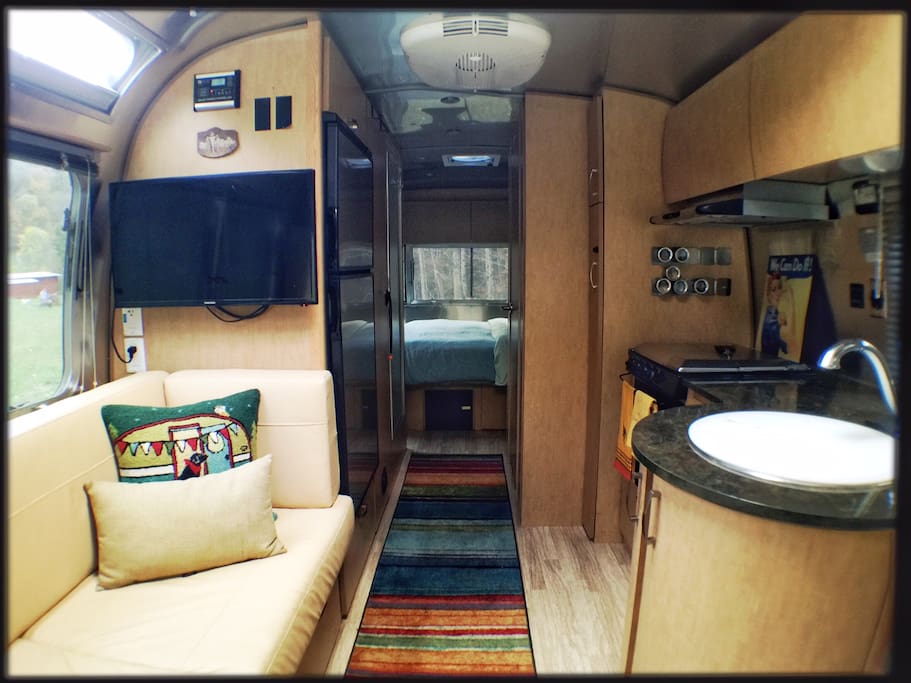 Kitchen includes propane stovetop, convection oven, full sized refrigerator, and dishes. Two flat screen tv's for watching dvds, after a day in the river or on the trail.