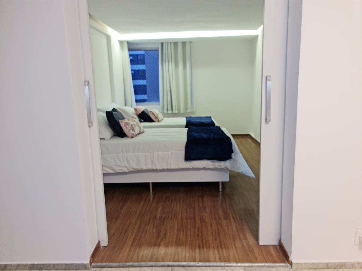 Спална соба 1, деми сопствен апартман, 2 единечни кревета на кои заедно има брачен кревет, клима уред од 10 милји btus, завеси со затемнување, дрвен под, широка лизгачка влезна врата, лесно сместување до креветот и/или луѓе со тежок превоз.