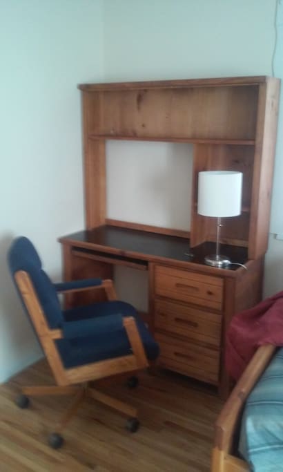 Disk and upholstered chair in bedroom with high speed internet.