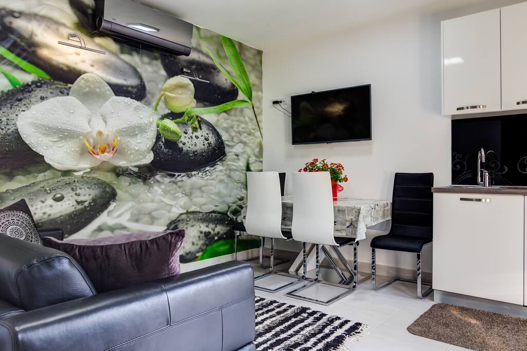 Living room with comfy sofa and dining area just across.
