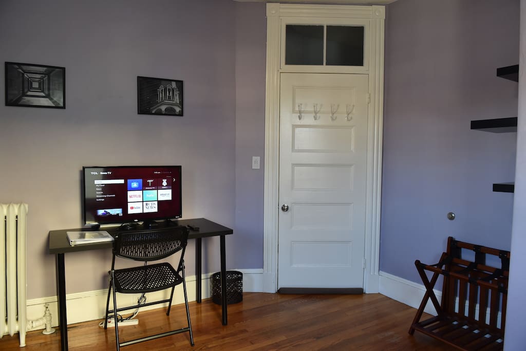 Wellington Room: View of the room from the bed. Amenities include door has coat/towel hooks, the desk & television and suitcase stands!