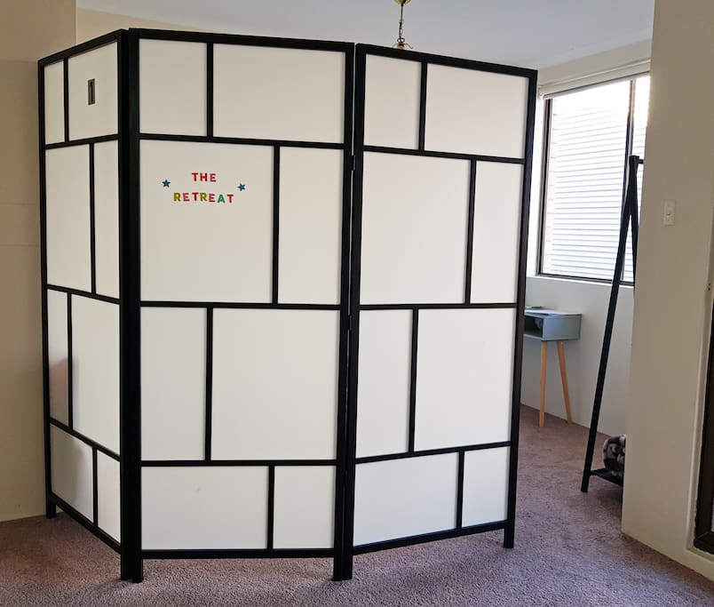A room divider for your privacy, it can close the entrance gap completely. Other bedrooms are upstair so at night the space is yours.