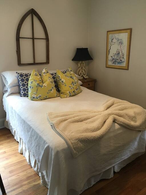 Queen sized bed with extra pillows.