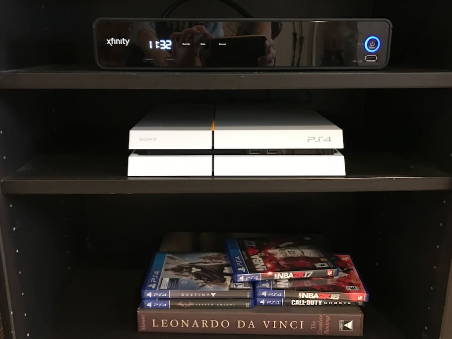 PS4 with games and two controllers.