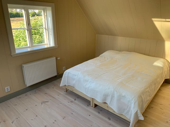 Bedroom overlooking rolling fields.