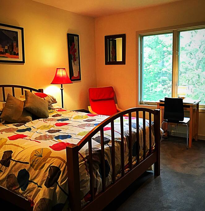 Queen bed, reading corner, forest view from windows.