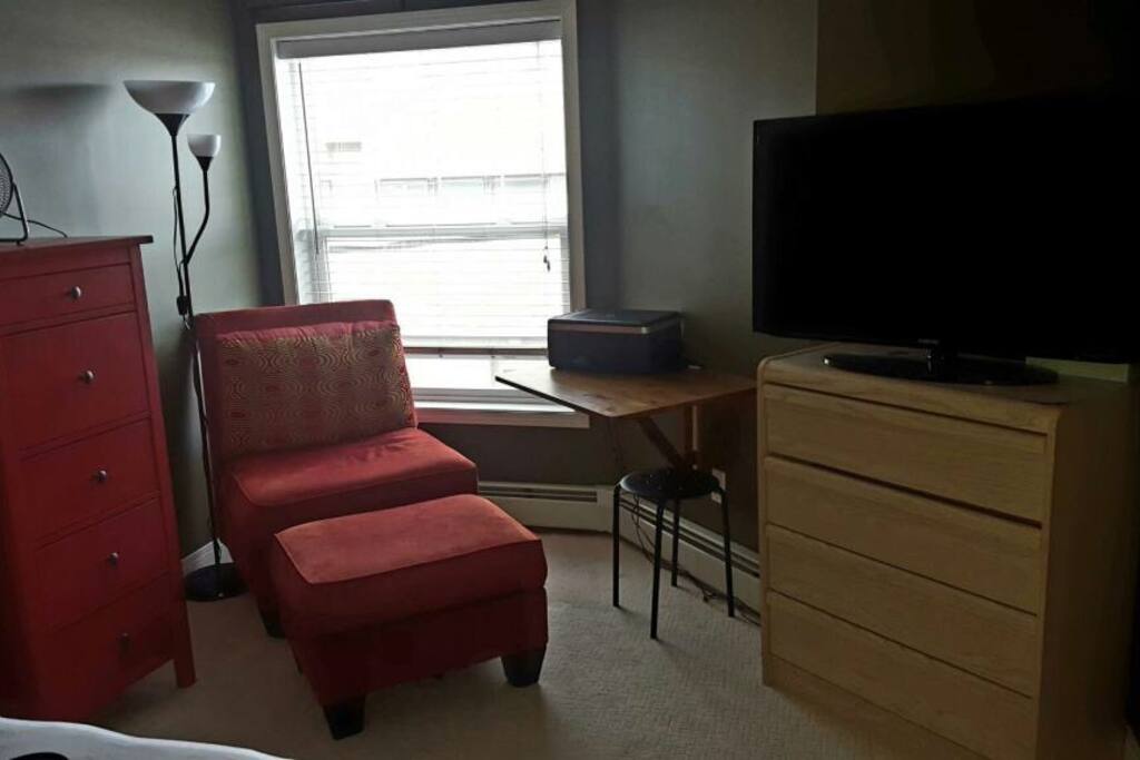 Workspace, lounging chair and TV with Netflix and cable.