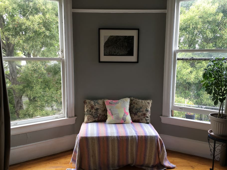 The corner, West-facing room. Nestled in a quiet yard but only 1 block from Haight St.