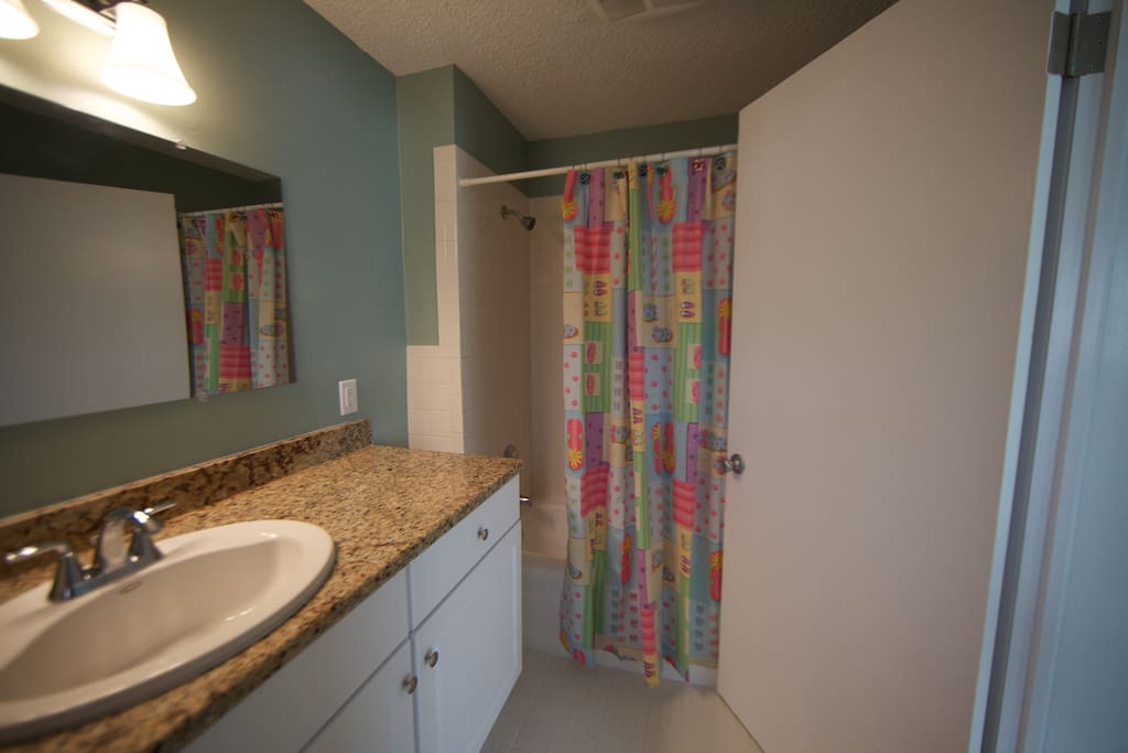 Fully renovated bath with granite counters and tub/shower combo