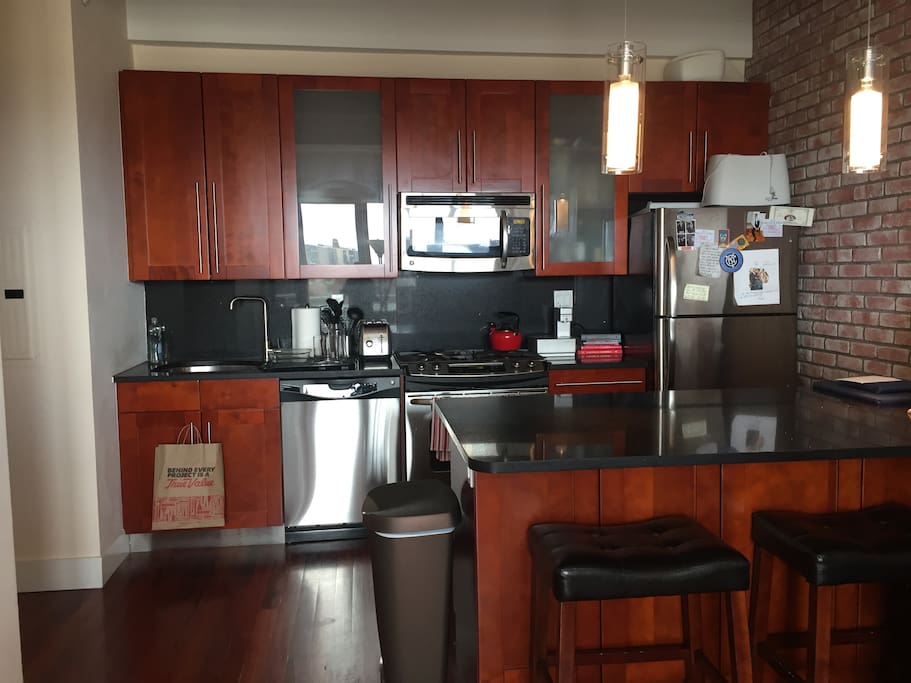 Full kitchen equipped with dishwasher, oven, microwave and refrigerator