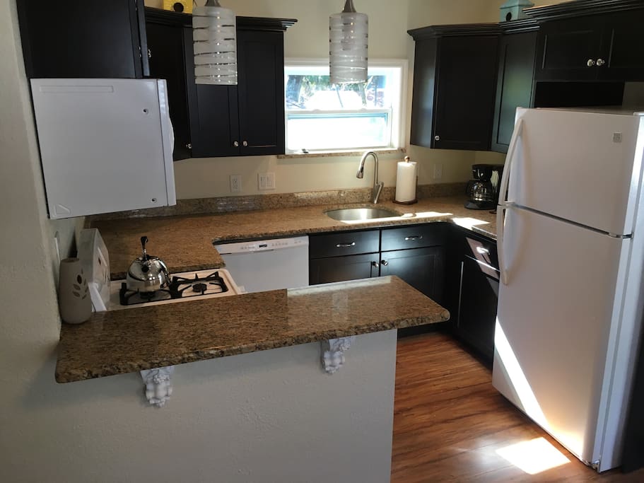 fully stocked kitchen: blender, toaster, microwave, pots, pans, etc.