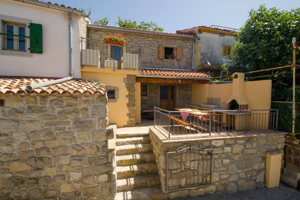 The front of the house and terase with outdoor kitchen and barbecue
