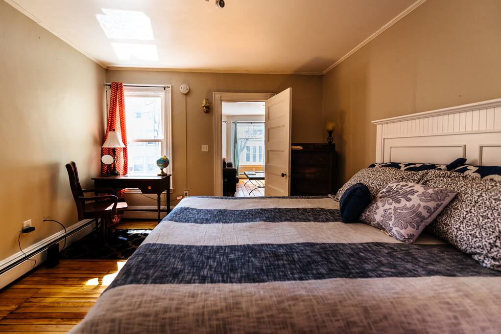 Bedroom with a queen tempur-pedic bed, looking out into the living room.