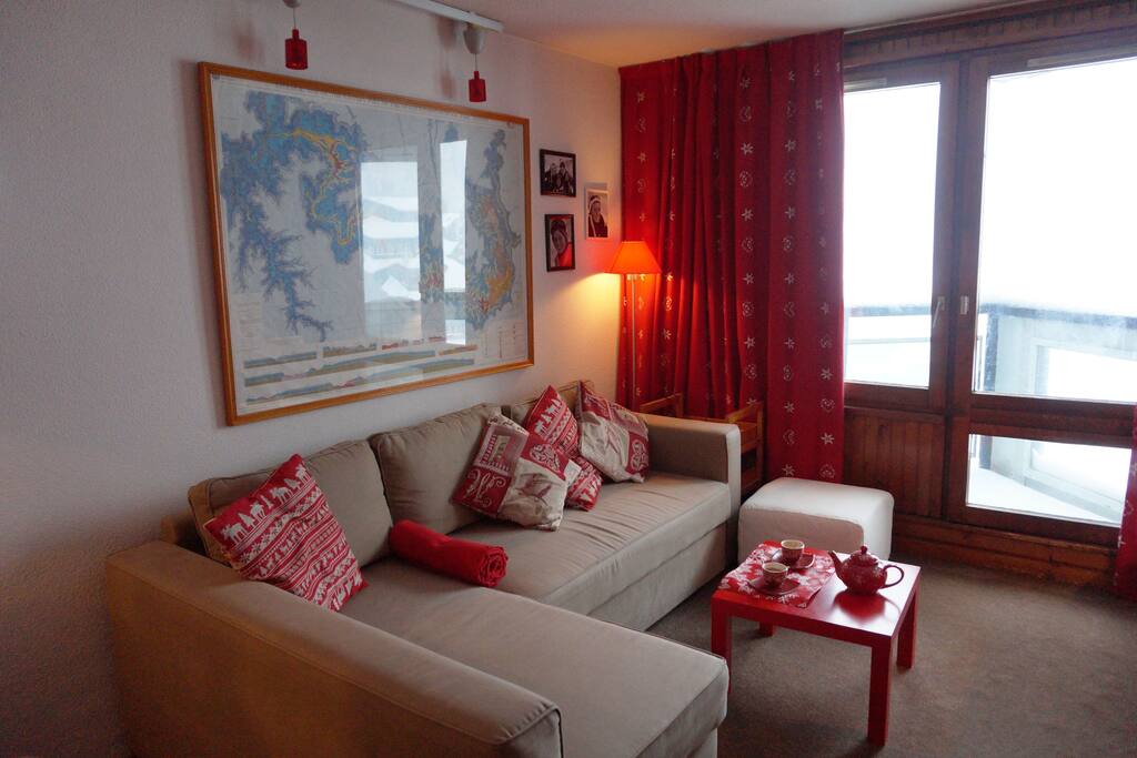 Le séjour, avec le canapé qui peut se déplier en lit pour la nuit ou pour regarder un film ou bouquiner après le ski...