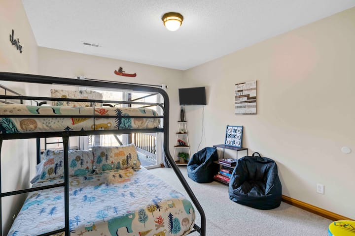 The downstairs bunk bed room is game central! The bunk beds can sleep 3 with a twin bed and a full bed. Wall mounted arcade game will keep you busy for hours :). You will have access to the lower deck, hot tub and fire pit from this room.