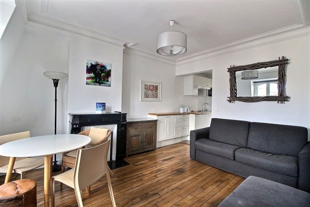 Living room with dining area and large sofa bed