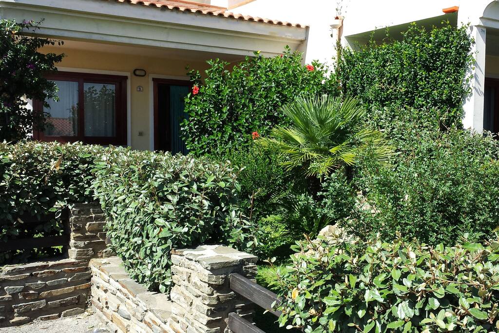 il giardino anteriore con siepe e muretto.