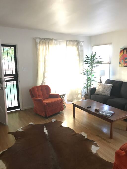 Bright and airy living room opens to deck and private front yard.