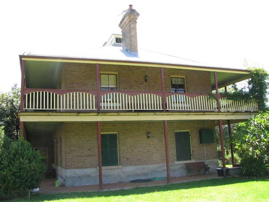 This lovely historic home features a large verandah upstairs and an inviting patio downstairs.