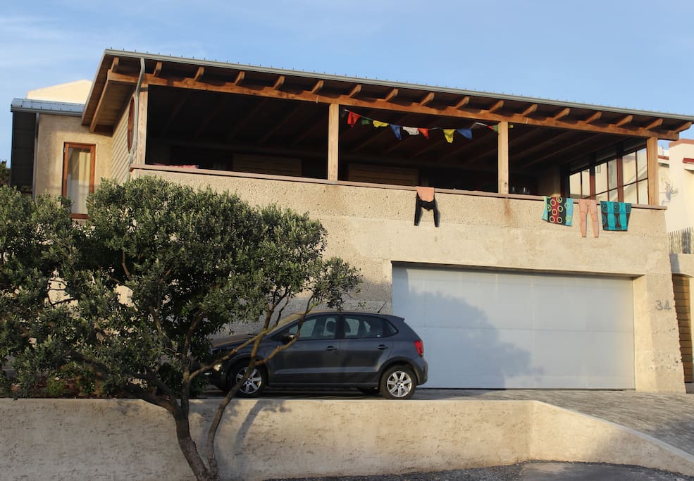 The Rustic Beach House with great views over the Atlantic Ocean & Table Mountain. It has a garage with space for 2 cars.