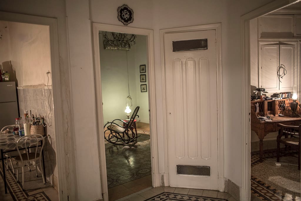 Triptych of rooms (from left, kitchen, living room, study, with pantry behind the closed door)