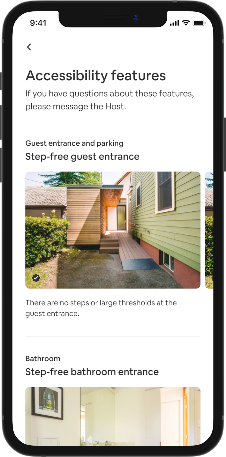 A mobile phone displays home details of an Airbnb listing. The main heading reads “Accessibility features” and features are grouped by area like “Guest entrance and parking” and “Bathroom”. Beneath "Guest entrance and parking" is the heading "Step-free guest entrance" and the feature description "There are no steps or large thresholds at the guest entrance." Below that is an image slideshow of photos of the feature at the listing, starting with a wheelchair ramp.