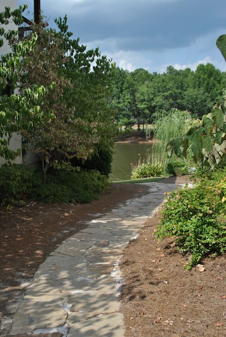 Stone pathway to back yard, docks, and lake.