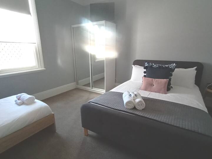 Second bedroom with Queen bed & double bunks with single beds