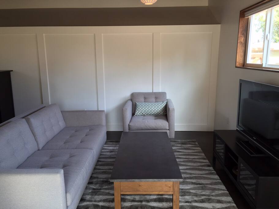 full living room area with furniture and large flat screen tv