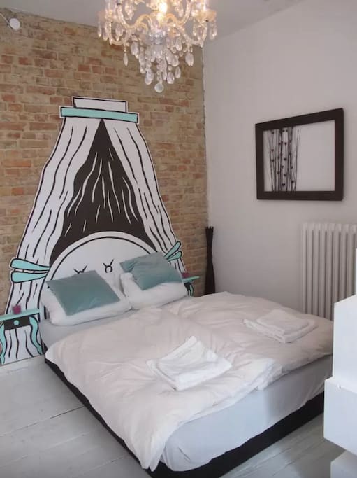 Cosy double bed with painted canopy