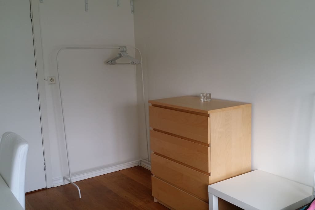 A drawer and cloth rack in the room