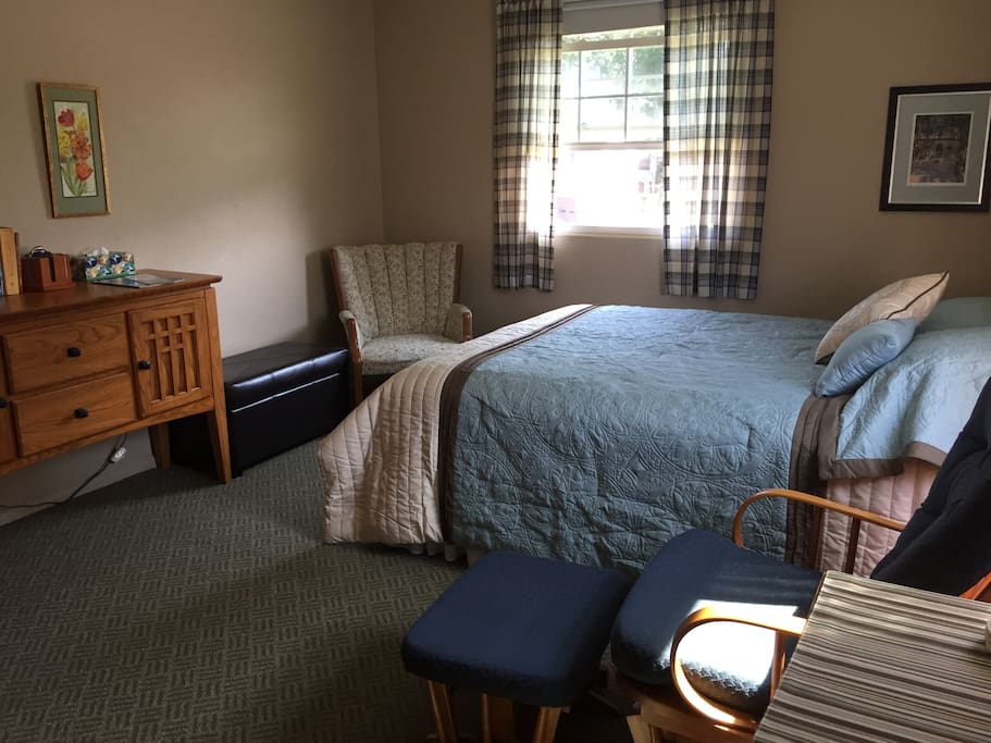 The queen bedroom with two windows.