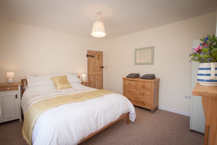 The comfortable King sized bedroom looks out over the gardens.
