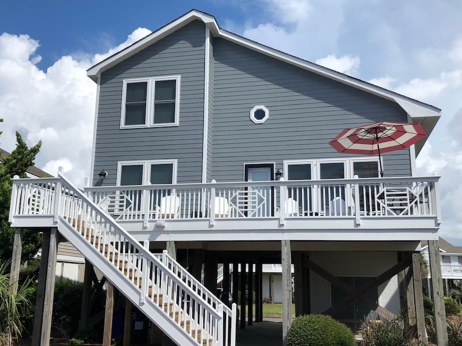 Side of the house facing the ocean. Brand new siding, paint, and windows.