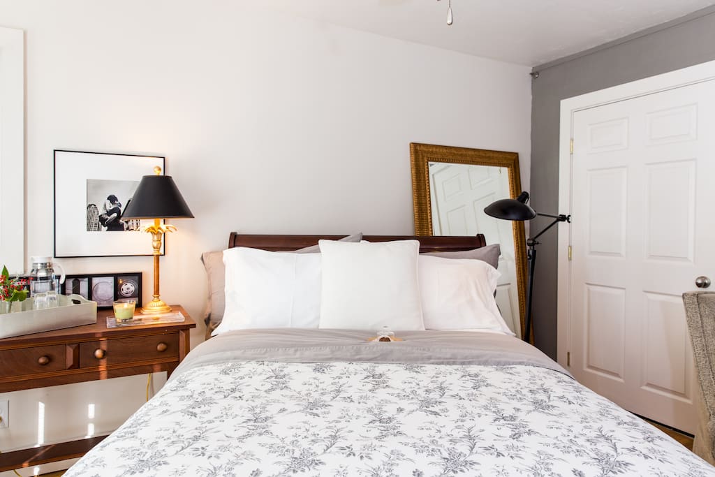 comfortable double size sleigh bed with bedside reading lamps
