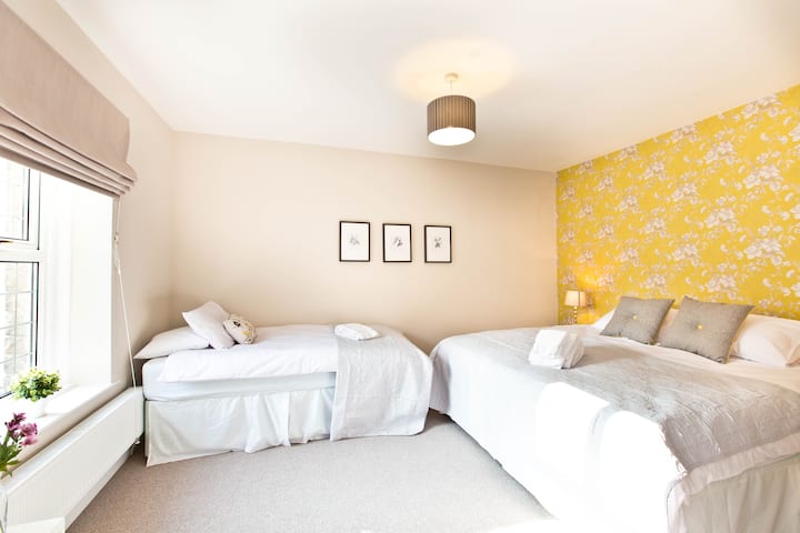 First floor bedroom 3, king or twin and a single bed with a shared bathroom. Spacious airy feel with a lovely feature wall paper wall 