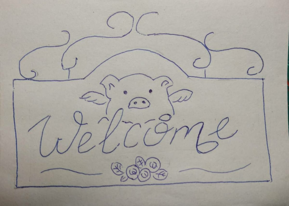 A hand-drawn welcome sign features a cartoon pig with wings above the word 'Welcome.' Floral illustrations adorn the bottom of the sign, adding a playful element to the design.